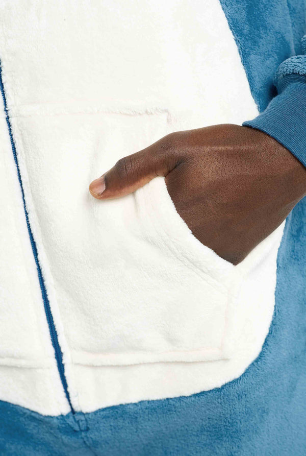 Close-up of a hand inside a pocket of a Snorlax onesie.