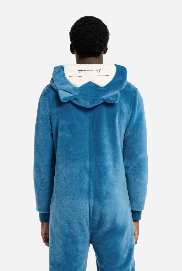 Person wearing a blue and white Snorlax onesie on a white background