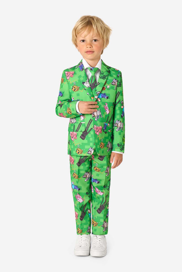 Child wearing a green suit with Minecraft pattern on a white background