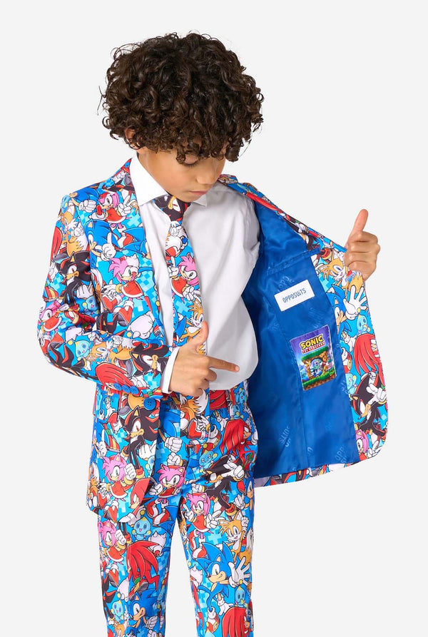 Child wearing a colorful Sonic-themed suit with a white shirt and blue jacket open, showing a label.