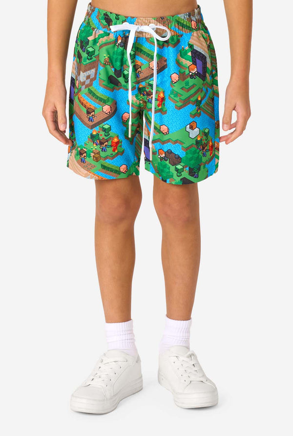 Colorful patterned Minecraft shorts worn by a person on a white background
