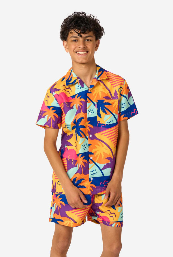 Person wearing a colorful Hawaiian shirt and shorts summer set on a white background.