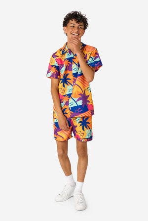 Person wearing a colorful Hawaiian shirt and shorts summer set on a white background. Full body image.