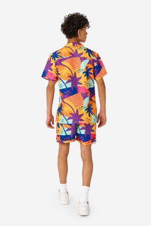 Person wearing a colorful Hawaiian shirt and shorts summer set on a white background. View from the back.