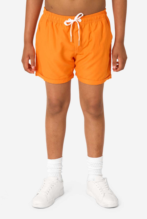 Person wearing bright orange shorts with a white drawstring on a white background
