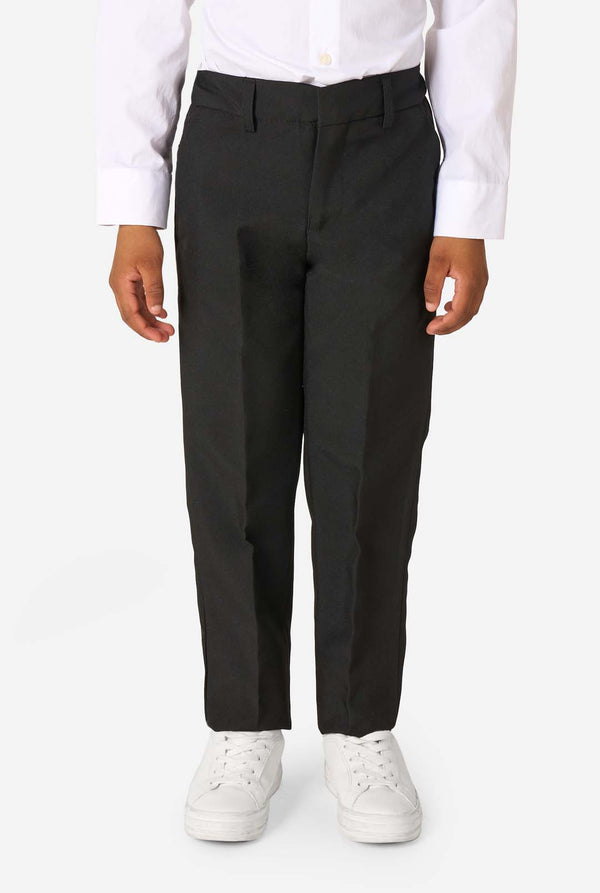 Person wearing black pants and white sneakers on a white background
