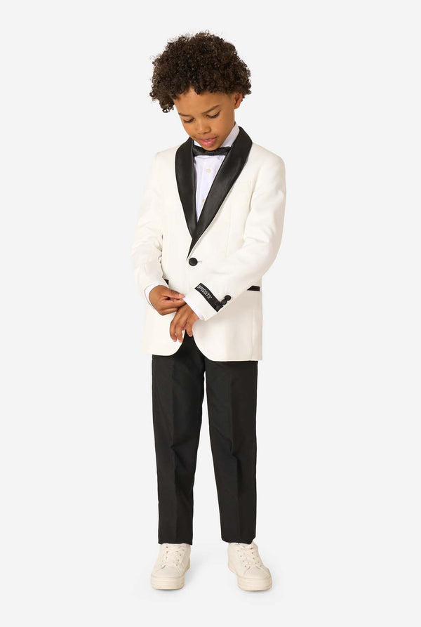Child wearing a white tuxedo with black lapels on a white background