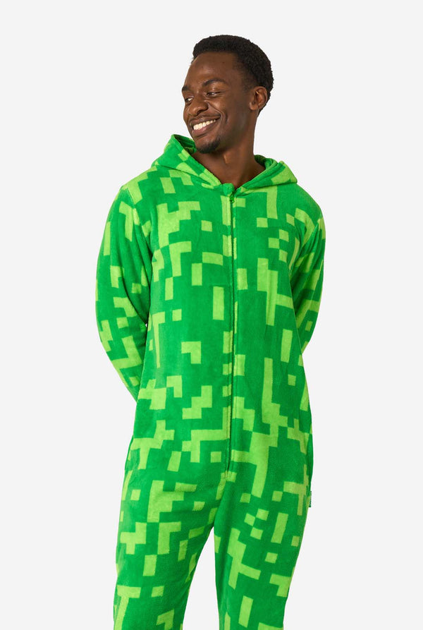 Person wearing a green pixelated Creeper onesie against a white background