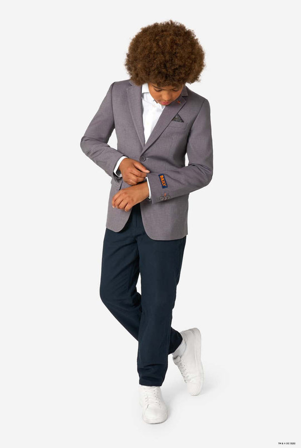 Person wearing a gray blazer and navy pants on a white background