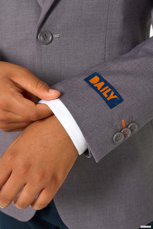 Close-up of the blazer sleeve featuring an orange “DAILY” label and grey buttons.