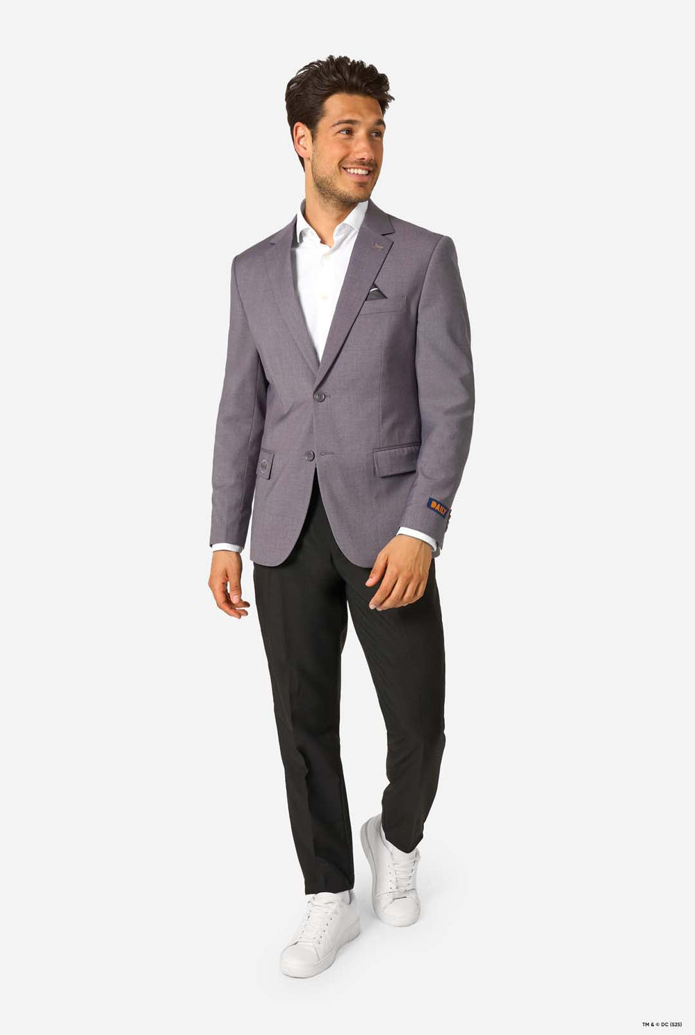 Man wearing a gray blazer over a white shirt on a white background