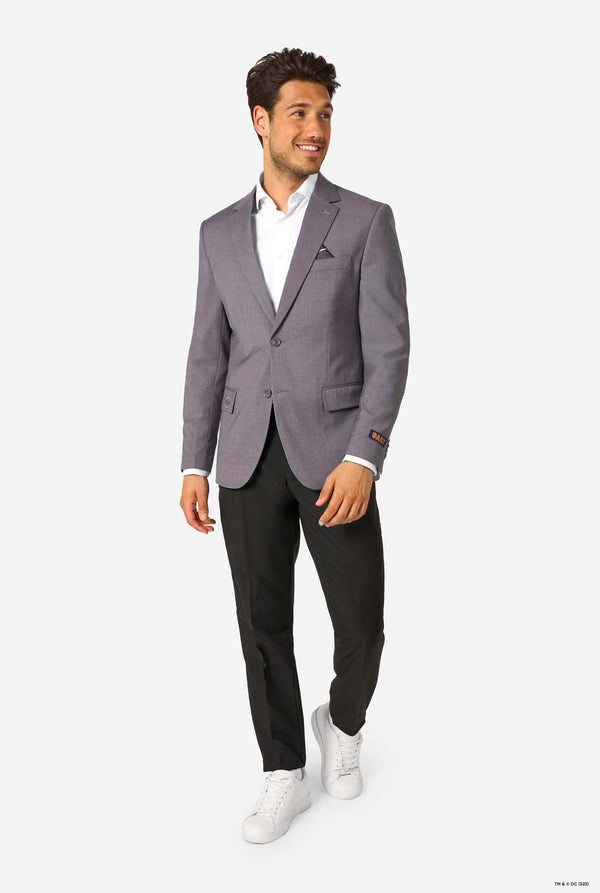 Man wearing a gray blazer, white shirt, black pants, and white sneakers on a white background. Full body image