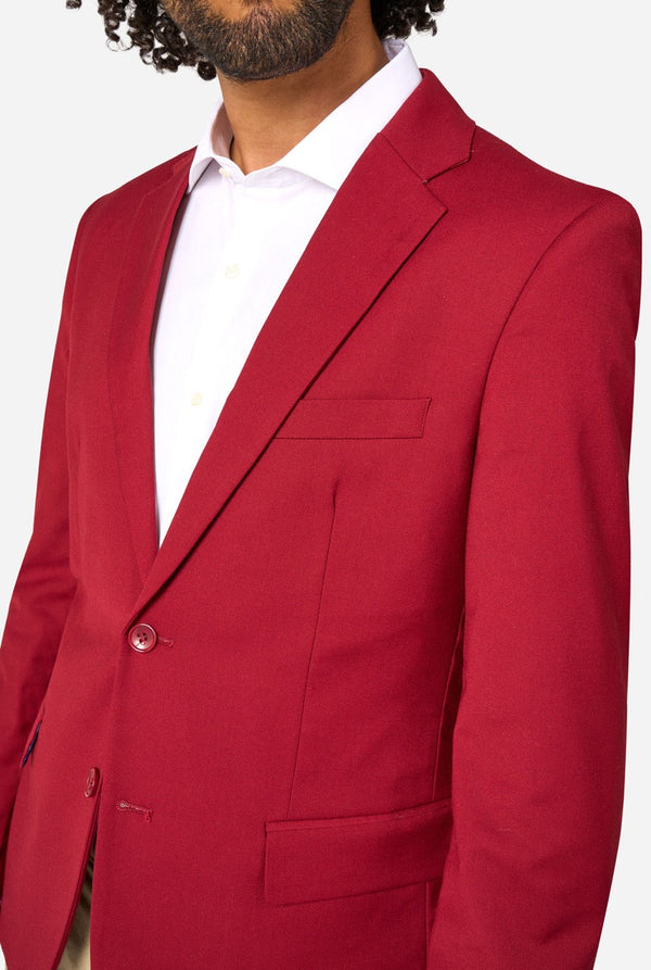 Red blazer worn by a person on a white background. Close up of the chest