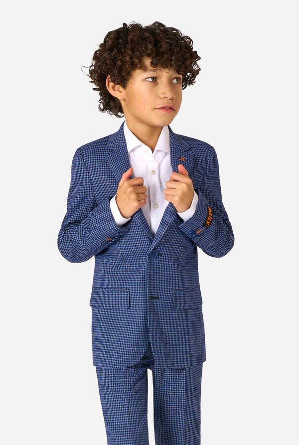 Child wearing a blue checkered suit with a white shirt on a white background