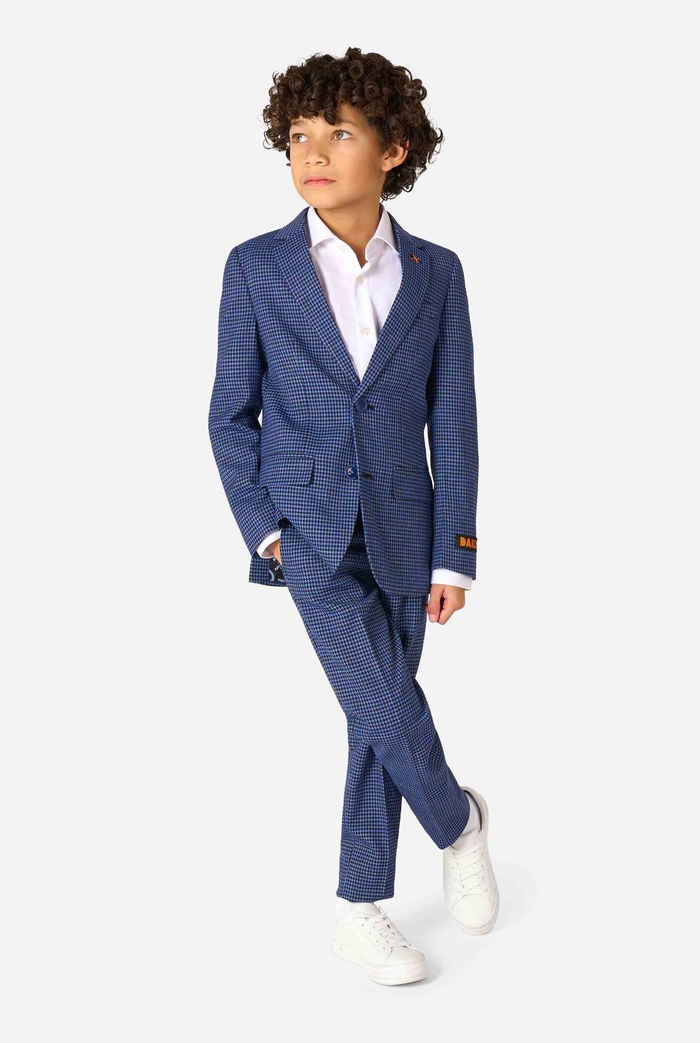 Child wearing a blue checkered suit with a white shirt on a white background