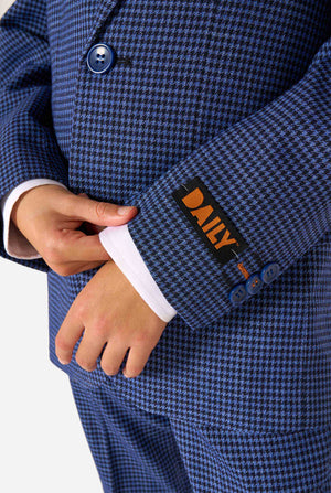 Close-up of a blue checkered suit with a DAILY label on a white background