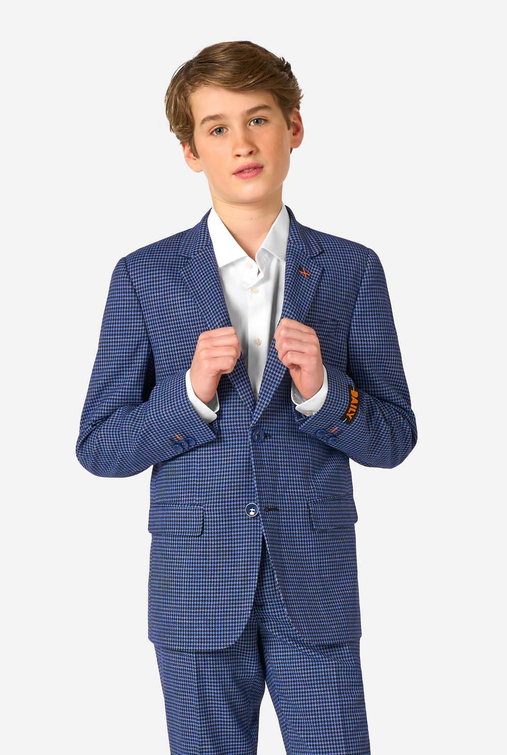 Young man wearing a blue checkered suit with a white shirt on a white background