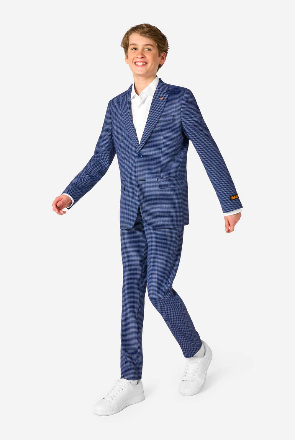 Young man wearing a blue checkered suit with a white shirt on a white background