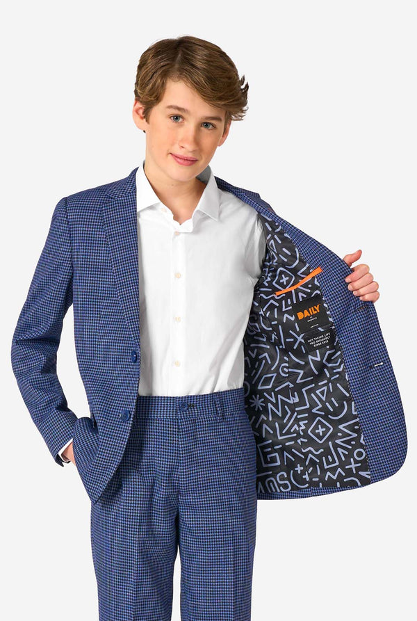 Young boy wearing a blue checkered suit with a patterned lining, holding the jacket open.