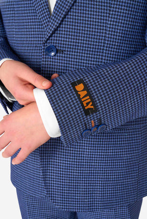 Close-up of a blue checkered suit with a brand label on a white background
