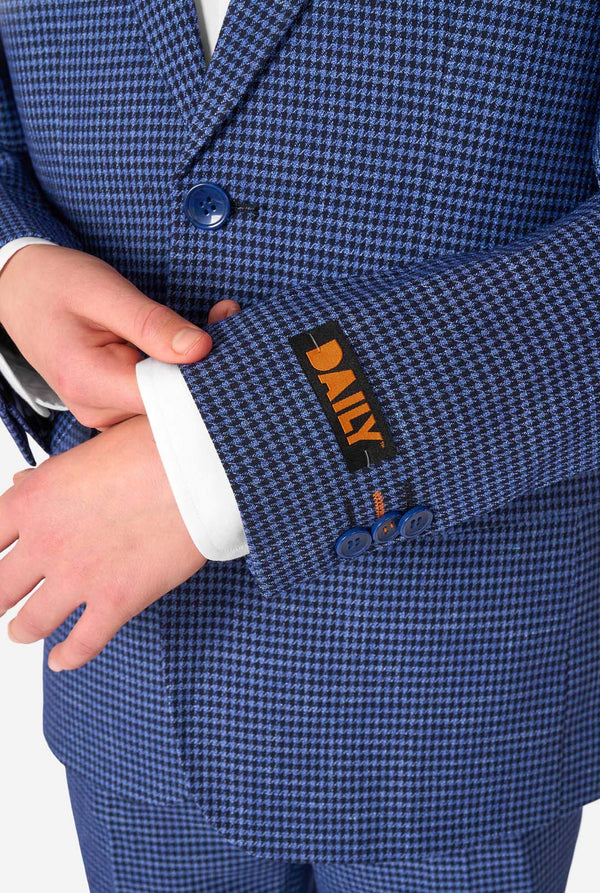 Close-up of a blue checkered suit with a brand label on a white background