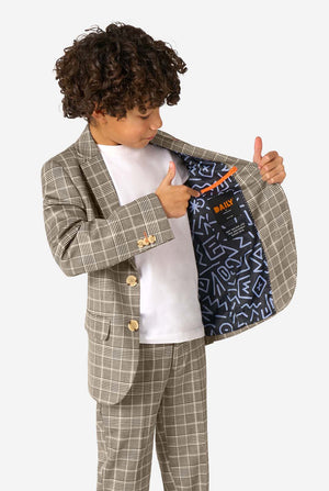 Child wearing a checkered suit with a white shirt featuring a colorful design.