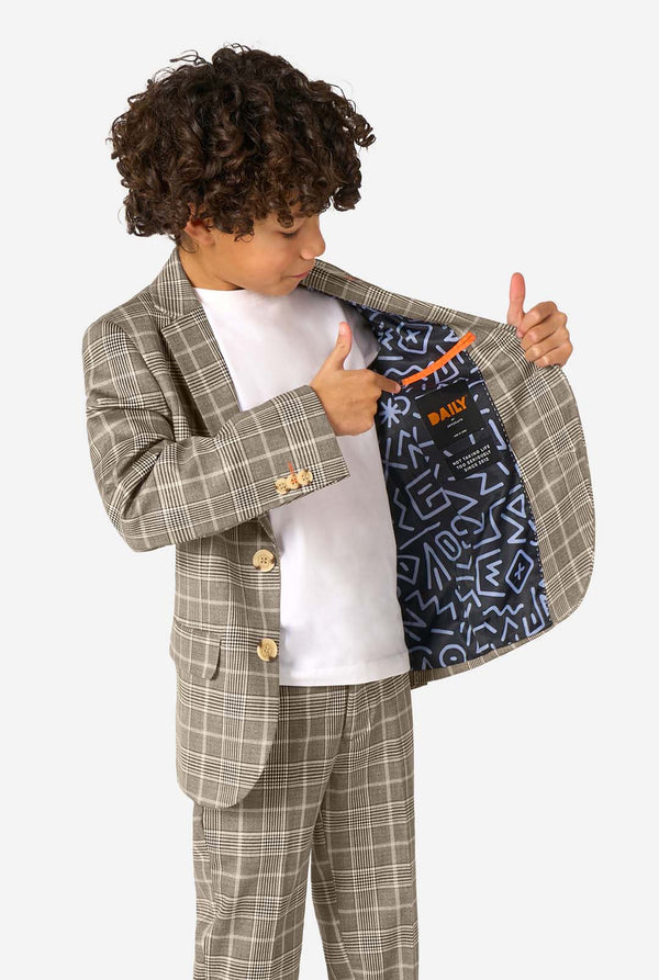 Child wearing a checkered suit with a white shirt featuring a colorful design.