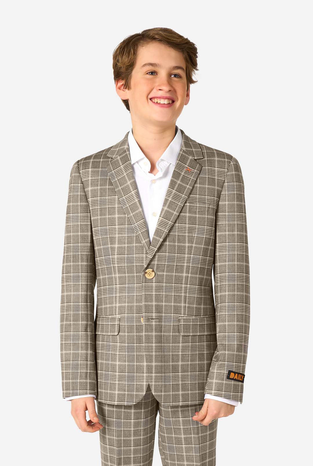 Young boy wearing a tan checkered suit with a white shirt on a white background