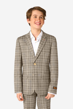 Young boy wearing a tan checkered suit with a white shirt on a white background