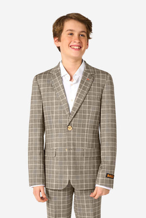 Young boy wearing a tan checkered suit with a white shirt on a white background