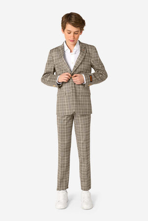 Person wearing a tan checkered suit with a white shirt on a white background