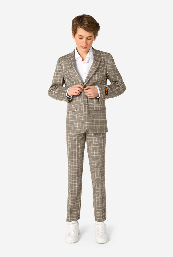 Person wearing a tan checkered suit with a white shirt on a white background