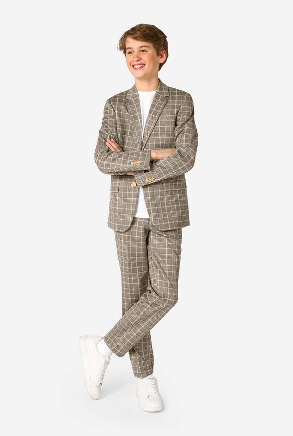 Person wearing a tan checkered suit with white shoes on a white background