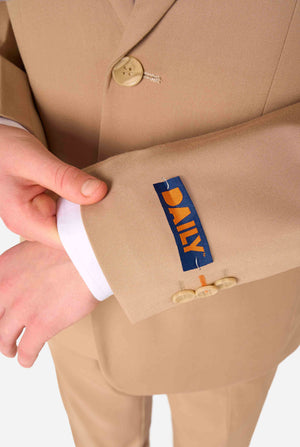 Teen boy wearing a stylish light brown/ beige suit with a white dress shirt, looking confidently in the camera. Perfect formal outfit for boys' special occasions, weddings, and parties. Sleeve close up.