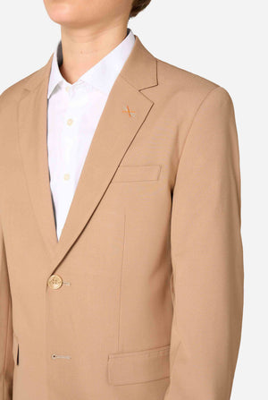 Teen boy wearing a stylish light brown/ beige suit with a white dress shirt, looking confidently in the camera. Perfect formal outfit for boys' special occasions, weddings, and parties. Chest close up.