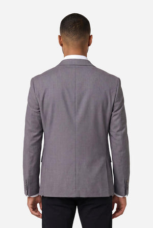 Man wearing a gray suit jacket on a white background. View from the back