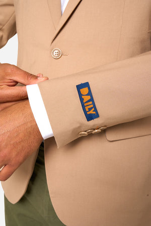 Close-up of a beige suit jacket with a Daily label on the sleeve.
