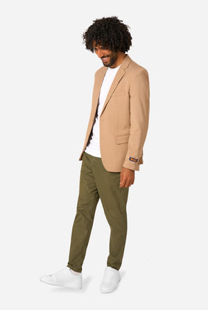 Man wearing a beige blazer, white shirt, and green pants on a white background. Full body image