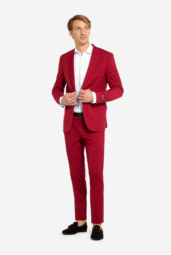 Man wearing a red suit with a white shirt on a white background. Full body image