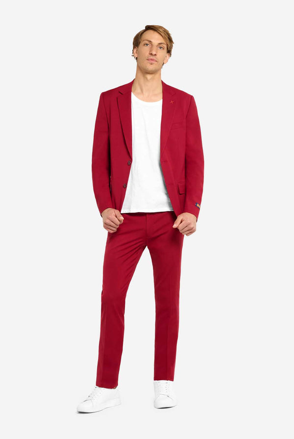 Man wearing a red suit with a white shirt on a white background. Full body image