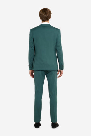 Image with light grey background and man wearing dark green men’s suit and white shirt. Suits consists of blazer and pants. Man facing away from the camera and showing the back of the suit. 