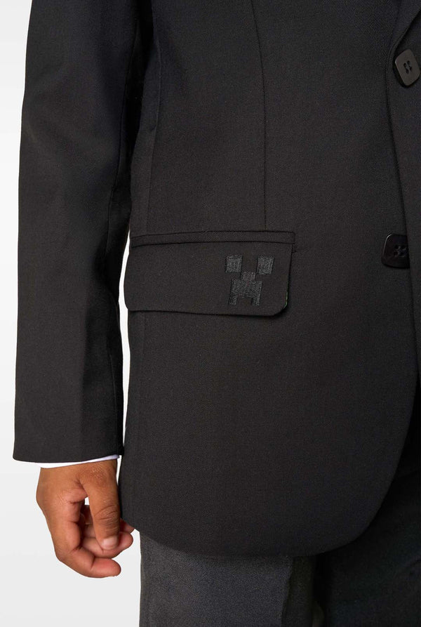 Black suit jacket with a patch on the chest against a white background
