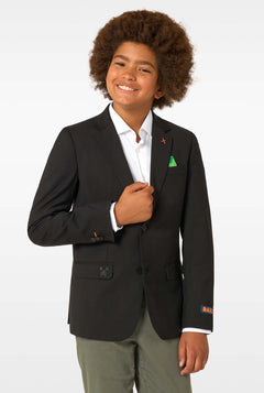 Child wearing a black blazer with colorful pins on a white background