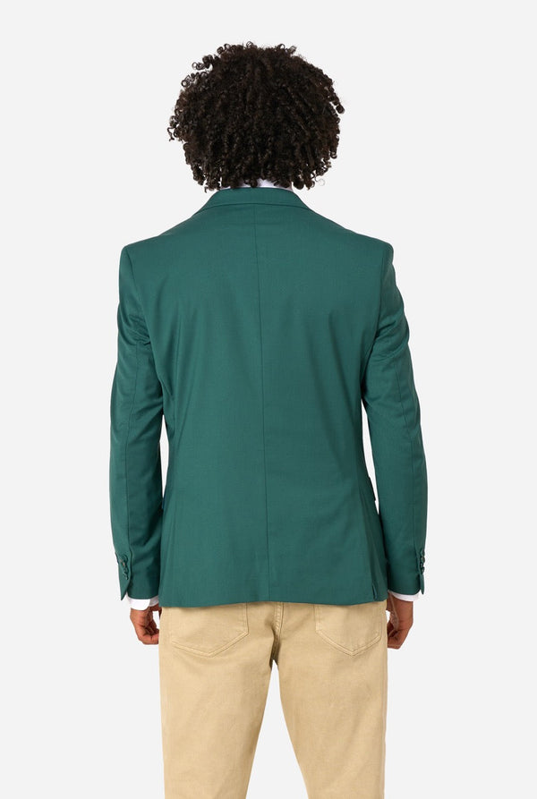 Person wearing a green blazer and beige pants on a white background. View from the back