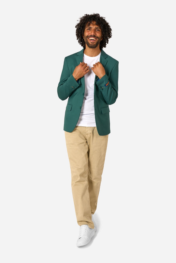 Man wearing a green blazer, white shirt, beige pants, and white shoes on a white background. Full body image