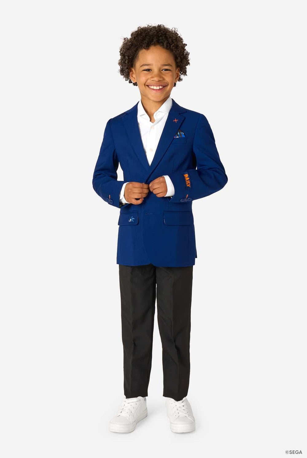 Kid wearing a blue Sonic-themed blazer with a white shirt and dark pants on a light gray background.