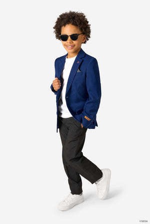 Kid wearing a blue Sonic-themed blazer with a white shirt and dark pants on a light gray background. Wearing sunglasses.
