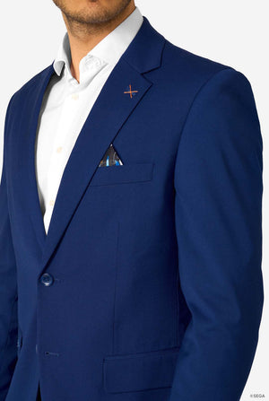 Man wearing a blue suit jacket with a white shirt and a pocket square on a light gray background