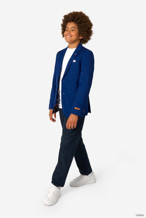 Person wearing a blue blazer with a Sonic logo, white shirt, navy pants, and white sneakers on a white background. Full body image