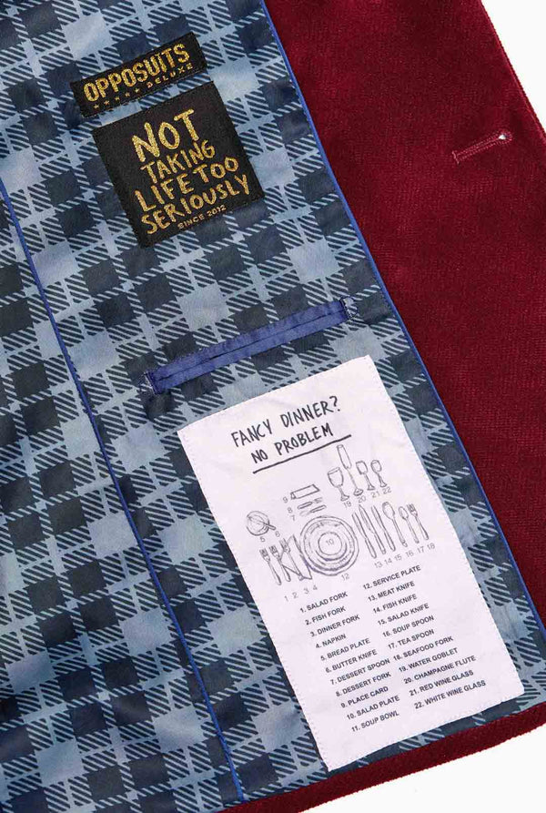 Man wearing burgundy red velvet Christmas blazer with Christmas icons, close up inside